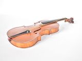 a violin that is sitting on a white surface