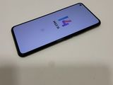a close up of a phone on a table with a logo on the screen