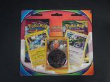 deux cartes Pokémon et une pièce de monnaie posées sur une table