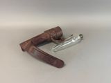a knife and a glass bottle on a table