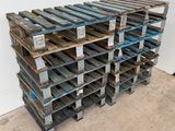several wooden pallets stacked on top of each other in a room