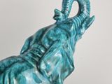 a statue of an elephant that is sitting on a table