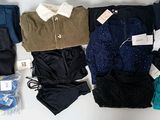 many different types of clothing laid out on a table