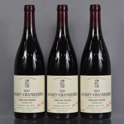 three bottles of wine are lined up on a table