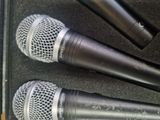 three microphones are sitting in a case on a table