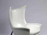 an image of a white leather chair with a wooden frame