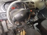 a dashboard of a small car with a steering wheel