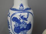 two blue and white vases sitting next to each other