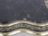 a close up of a black and gold box on a table