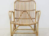 a wicker chair that is sitting in a room
