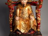 an image of a statue of a man sitting on a throne