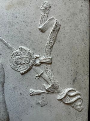 a relief of a man holding a sword and a shield