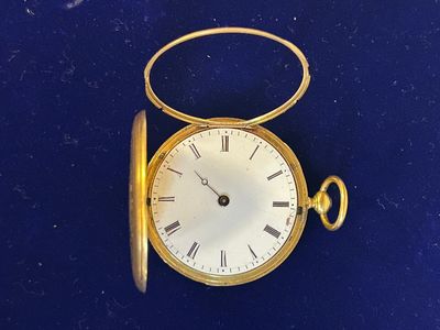 une montre de poche en or avec des chiffres romains
