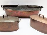 three copper colored pots and pans sitting next to each other