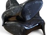 a pair of black shoes that are on top of each other