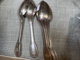 silver spoons, forks and spoons on a table