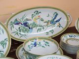a lot of plates and bowls that are sitting on a table