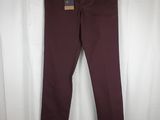 a pair of burgundy colored pants hanging on a white curtain