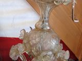 a glass chandelier with a bird on top of it