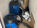 a blue vacuum and a blue bucket in a room