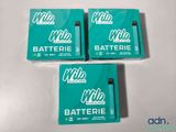 three boxes of batteries sitting on top of a white table