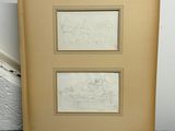 deux dessins encadrés représentant une ville et un bâtiment, posés sur un sol en marbre