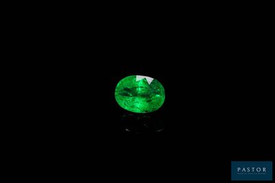 a green emerald gems on a black background