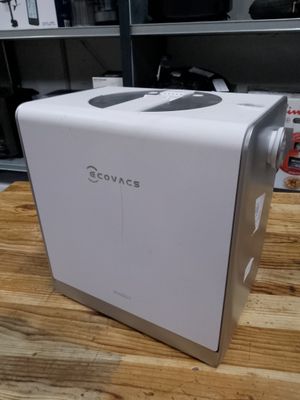 a white toaster sitting on top of a wooden table