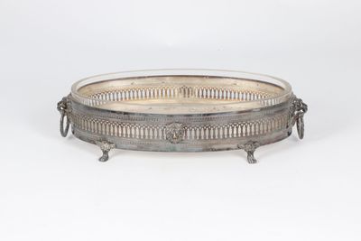 an antique silver plate with handles and handles on a stand