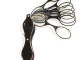 a pair of scissors and a pair of glasses on a white surface