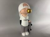 a figurine of a man wearing a hat and holding a skateboard