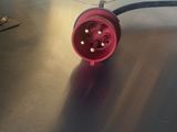 an image of a red electrical plug on a table