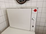 a white microwave oven sitting on top of a white counter