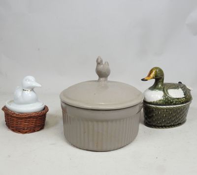 three ceramic ducks sitting on a table next to each other