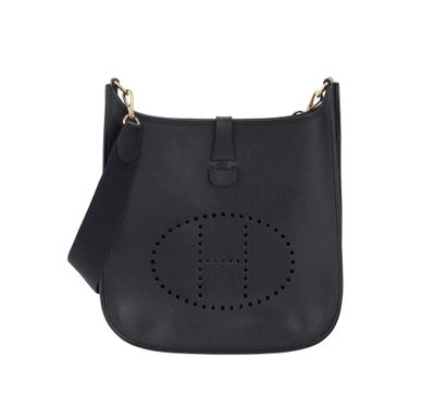 a black leather cross body bag with a logo on the front