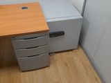 a desk with two drawers and a computer monitor on it