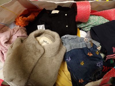 a bag full of clothes and a teddy bear in it