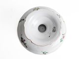 a white bowl with a floral design on it