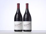 two bottles of red wine sitting next to each other on a table