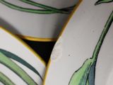 a close up of a plate with a flower on it