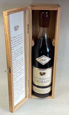 a bottle of wine in a wooden box on a table