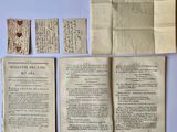 several pieces of old paper are laying out on a table