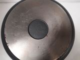 a metal object that is sitting on a white surface