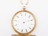 an old gold pocket watch with roman numerals and roman numerals on the face