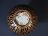 a gold plate with writing on it sitting on a table