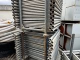 a pile of metal pipes stacked on top of each other