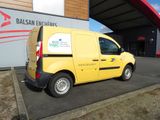 a yellow van that is parked in front of a building