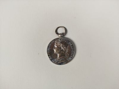 a close up of a coin on a white surface with a white background