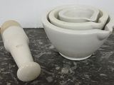 three bowls and a mortar on the table