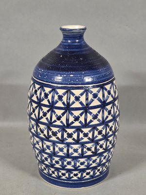 a blue and white vase sitting on a table